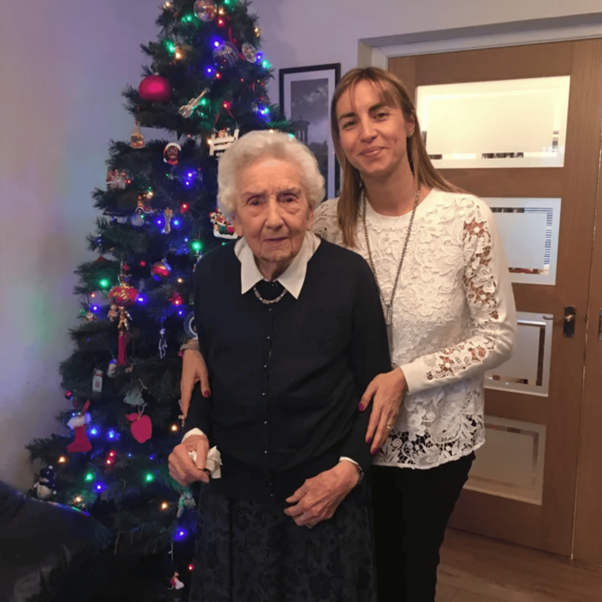 photo of me with my Granny on Christmas Day beside our Christmas tree