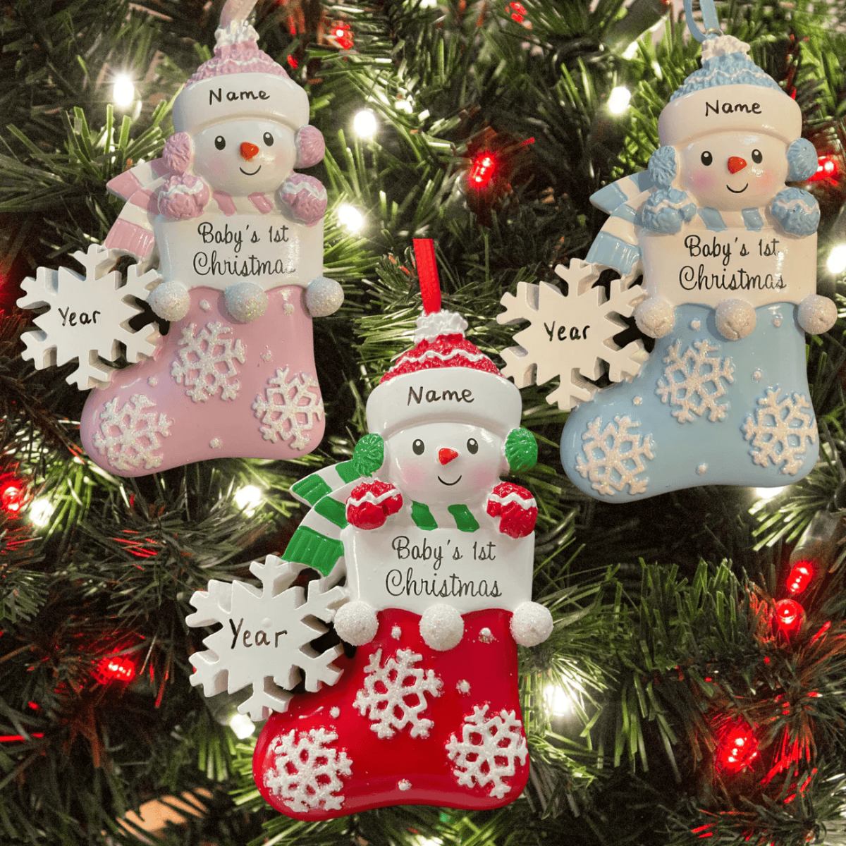 personalised christmas tree decorations in 3 colours for a baby's first christmas of a snowman in a stocking