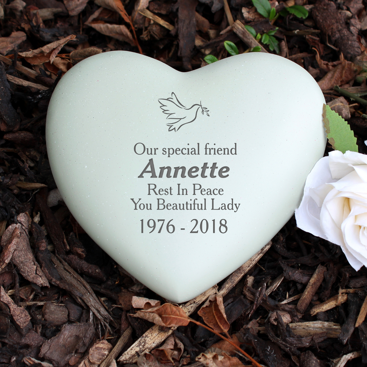 personalised dove memorial stone showing the person's name, message and age engraved on the heart stone