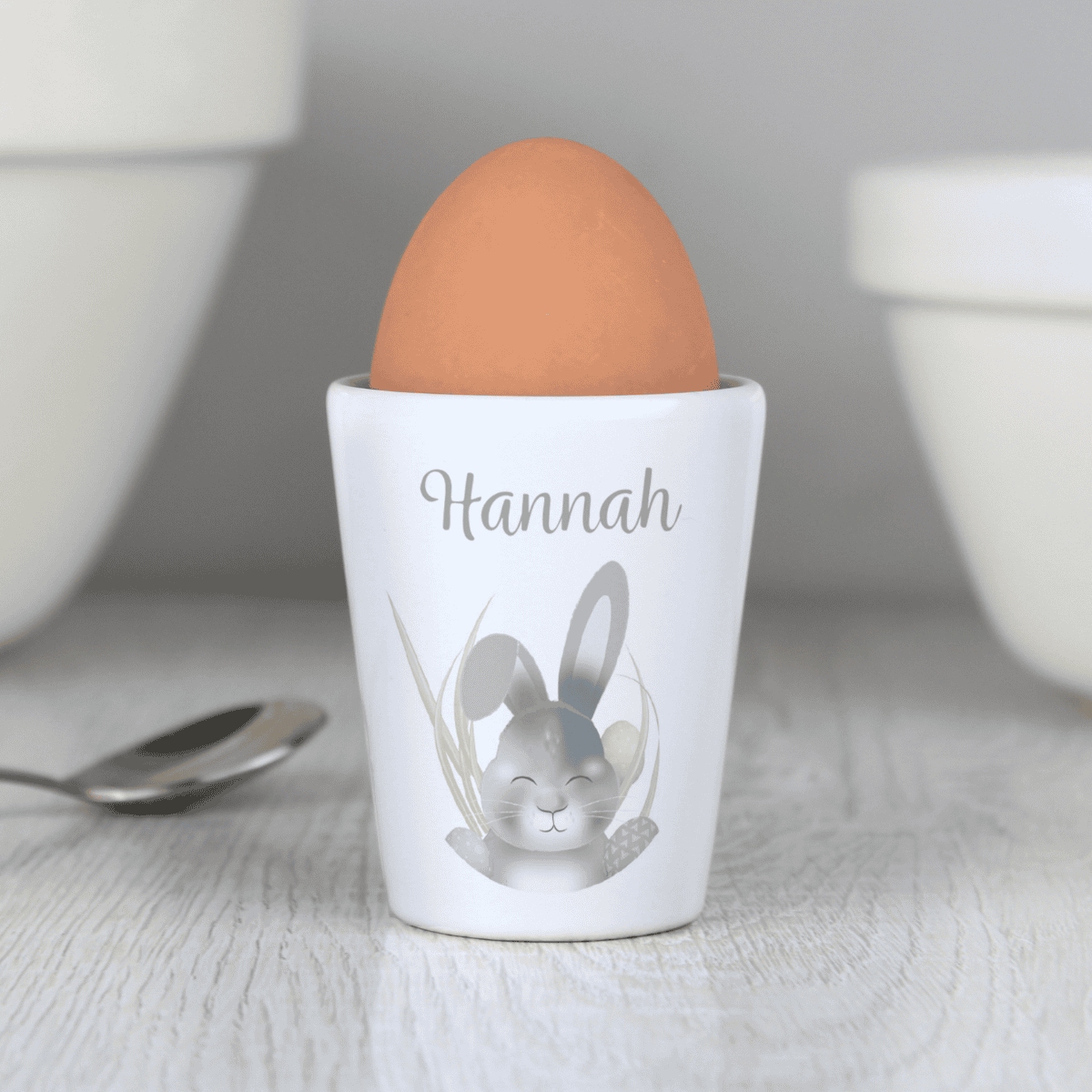 white ceramic easter bunny egg cup showing the personalisation on the front above the bunny design