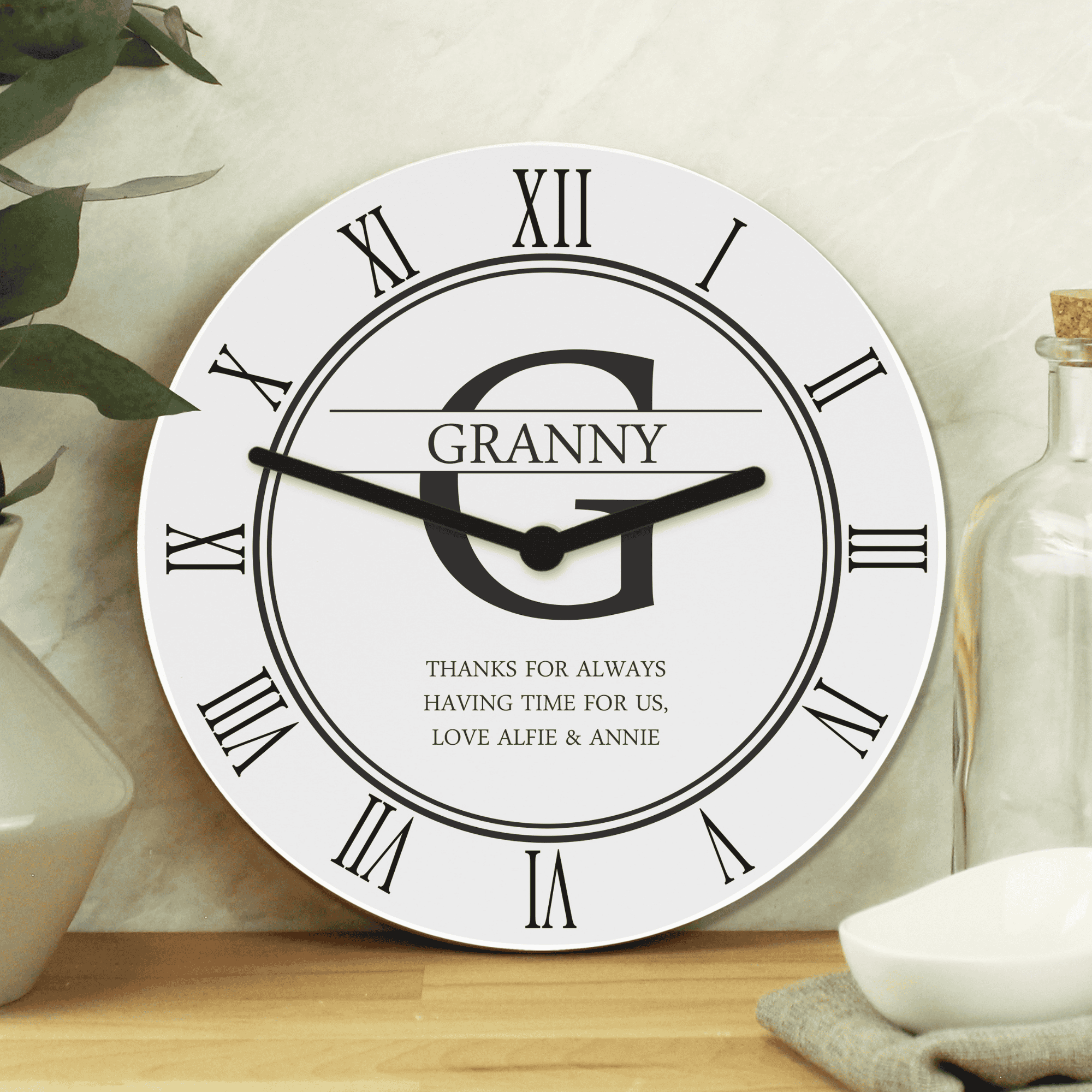 personalised white family clock with initial, surname and message.