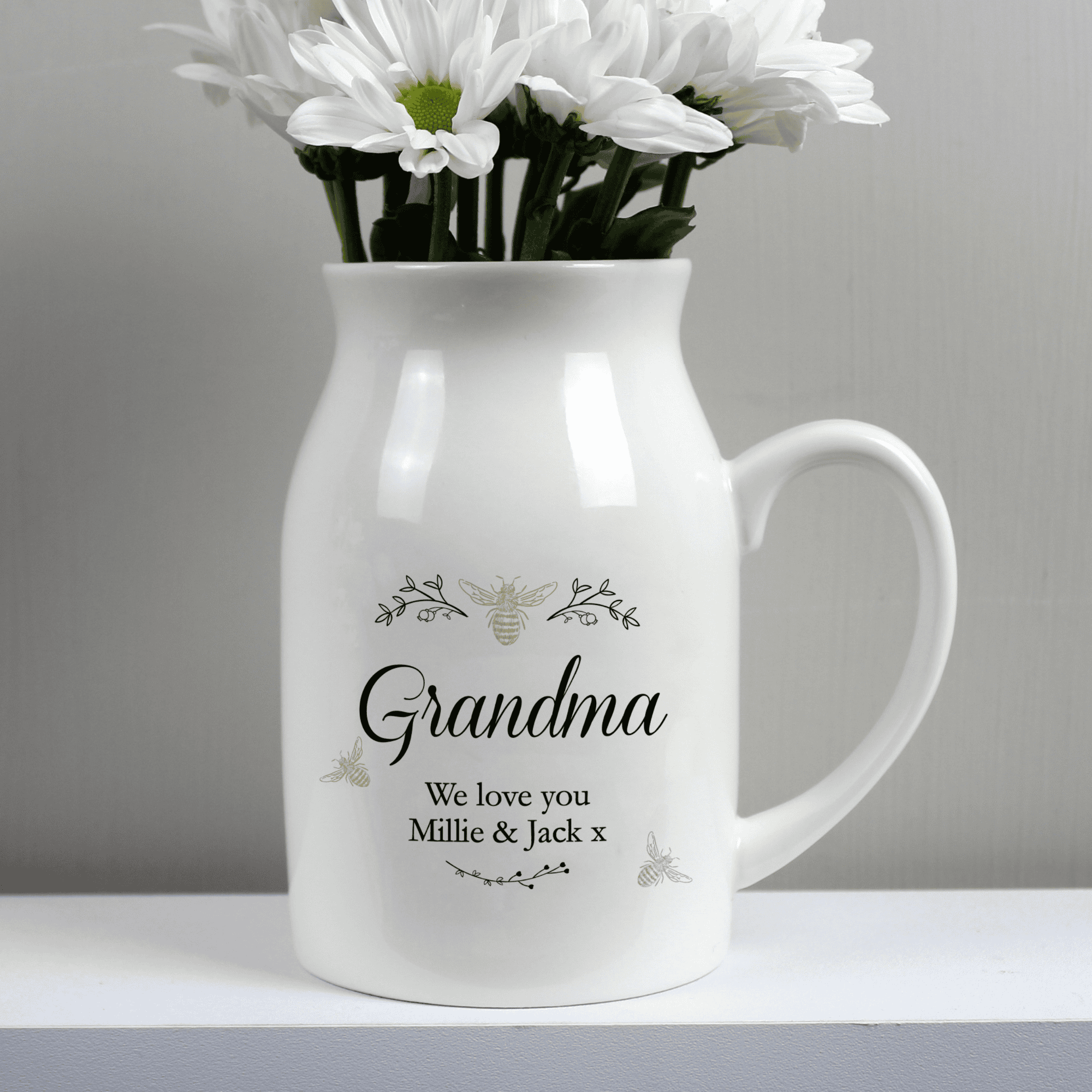 personalised ceramic jug vase with a floral bee design and a name in larger font and message over 2 lines underneath