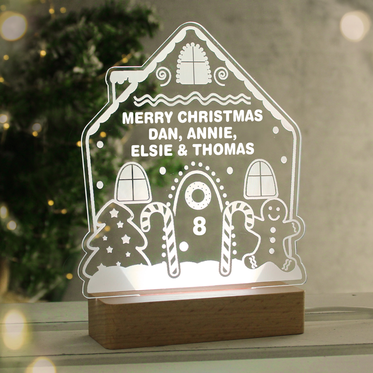 personalised gingerbread LED house showing it lit up in white