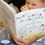 personalised Tiny Tatty learning book showing the front cover with the child's name on the book and the child reading it with an adult