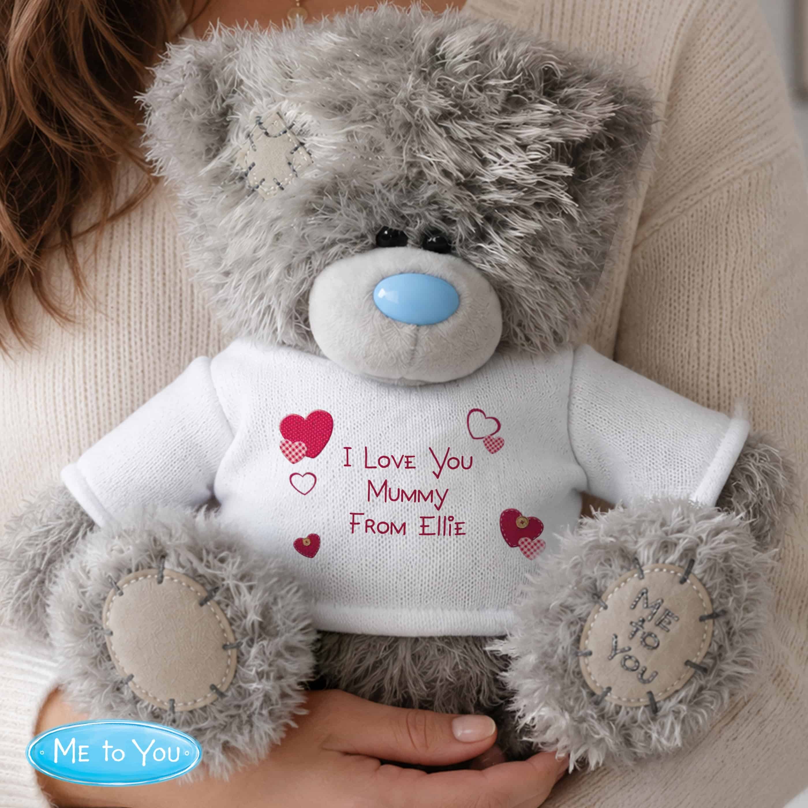 personalised teddy bear with a white jumper and personalisation over 3 lines in red
