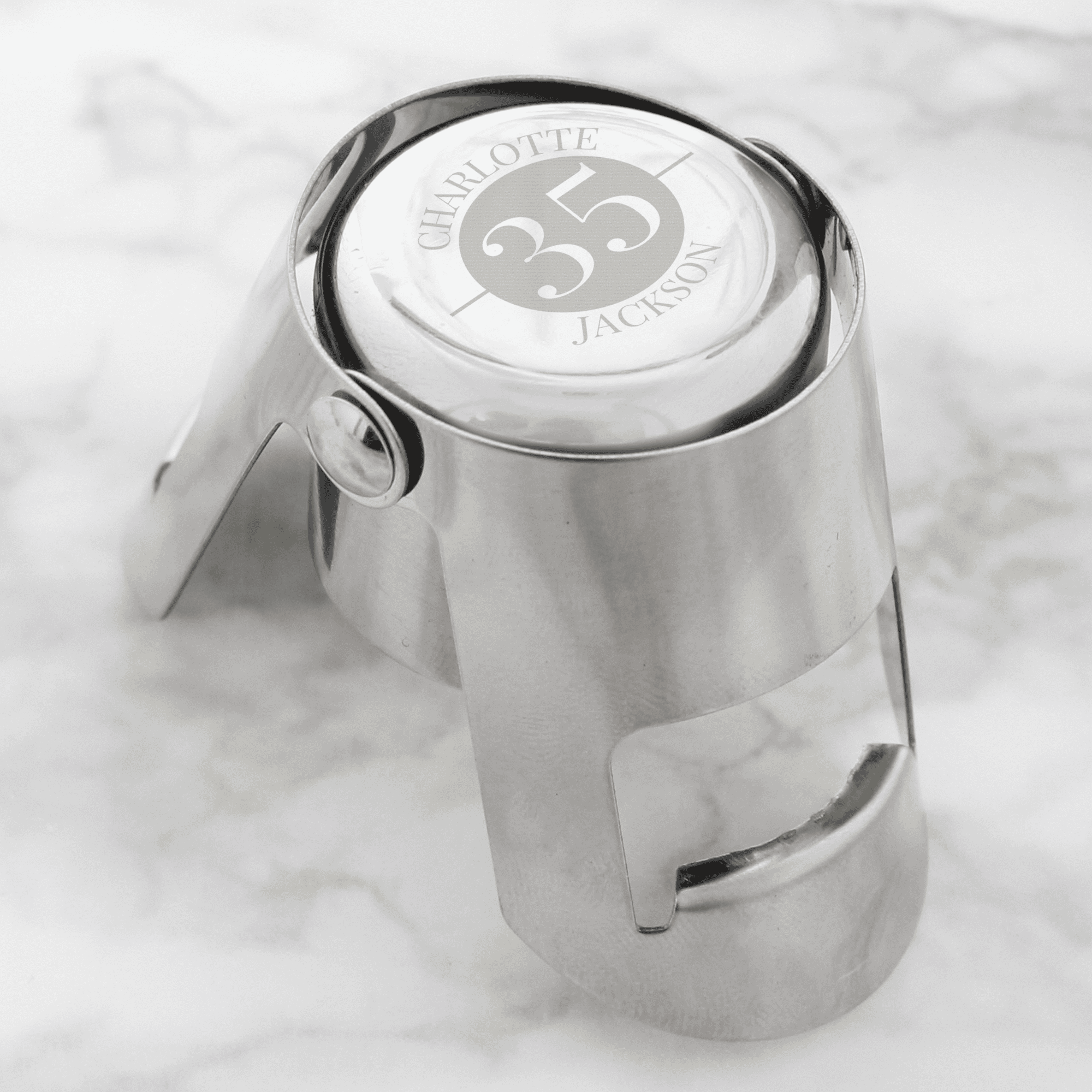 personalised metal bottle stopper that can be engraved with a year and a message above and below it
