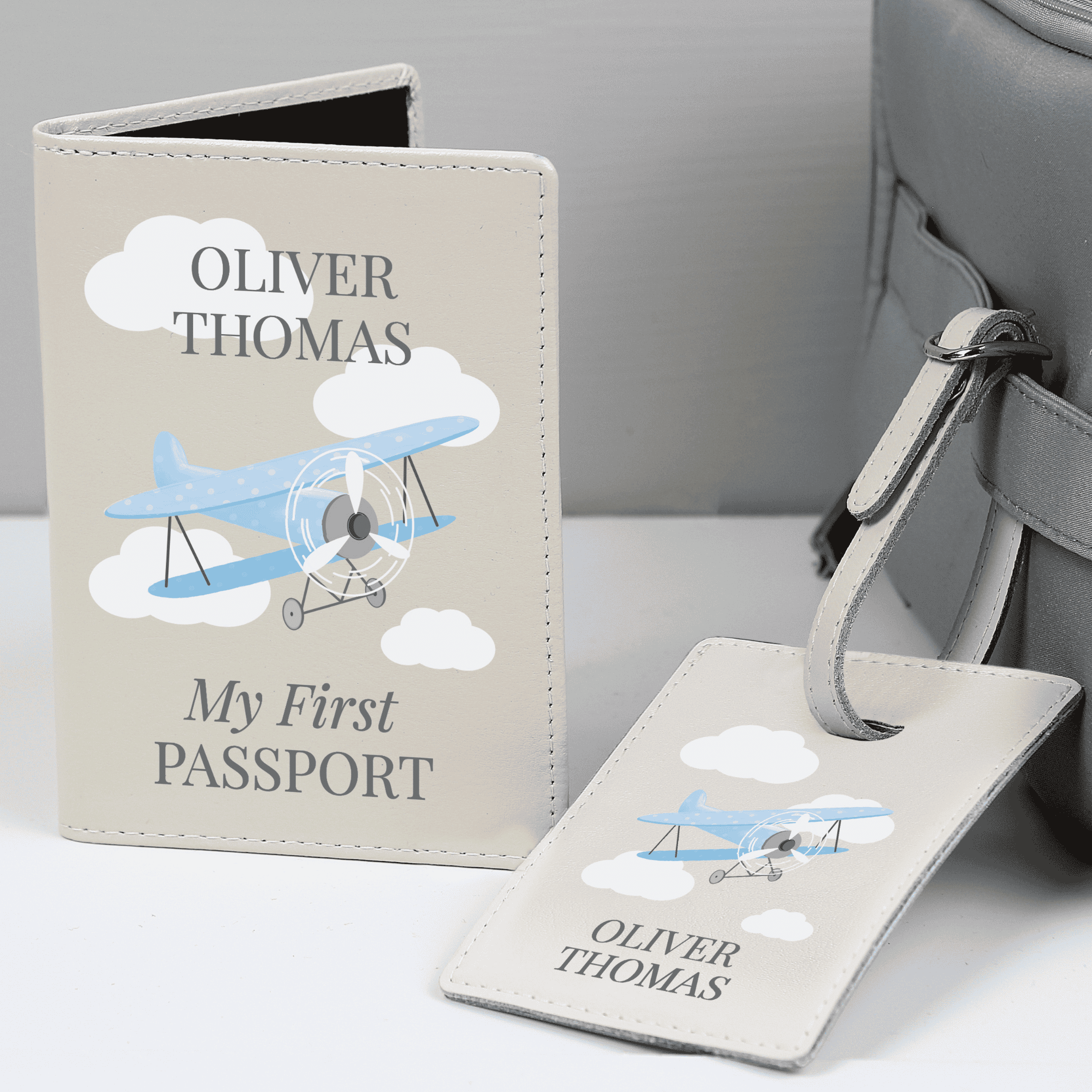 personalised passport cover and luggage tag with a blue plane design on the front