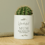 personalised ceramic storage pot. white with a botanical design and personalised over 4 lines with the name in big writing