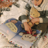 personalised christma story book showing the pages illustrated inside and a children holding their personalised teddy