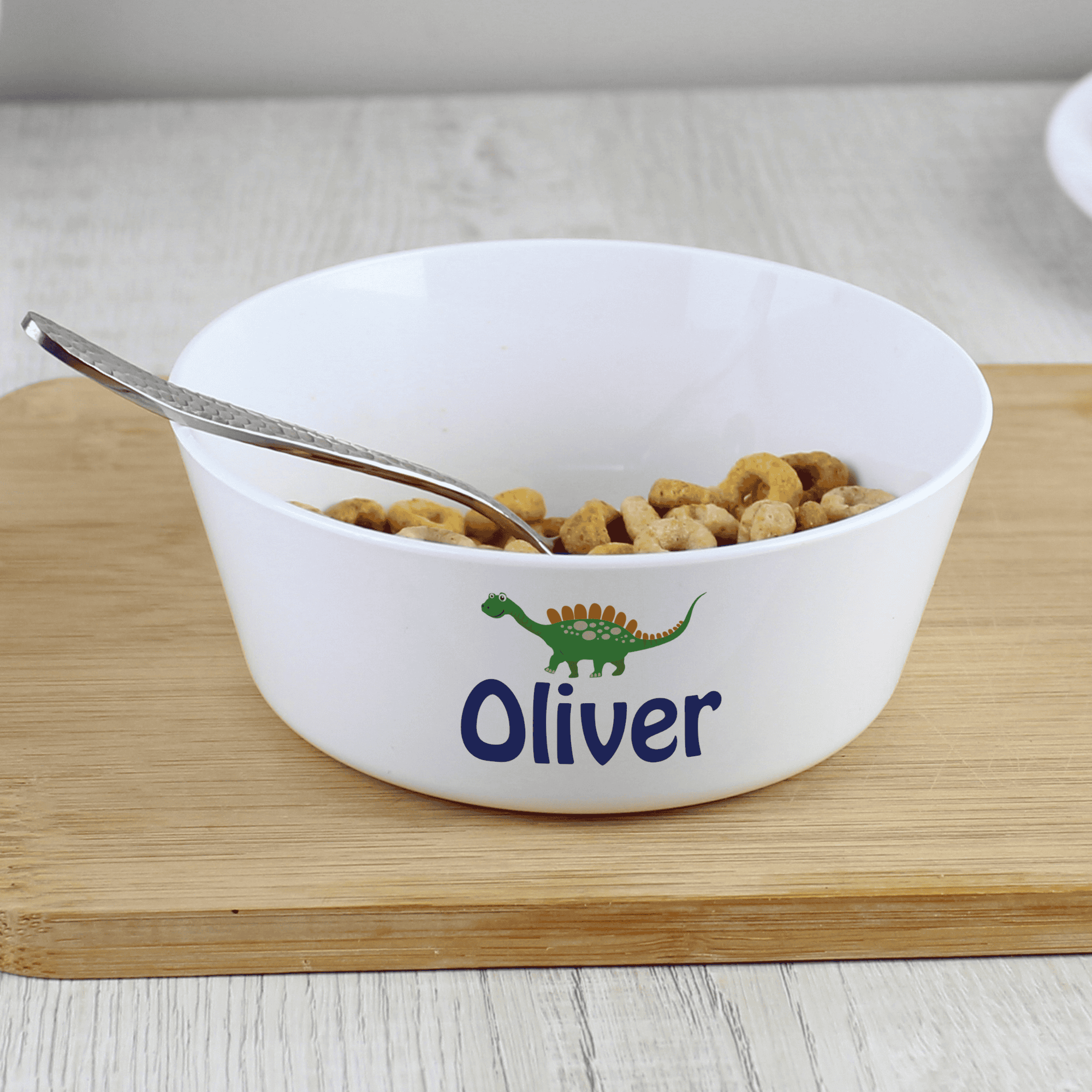 personalised dinosaur plastic bowl with any name personalised on the side of the bowl below a dinosaur image