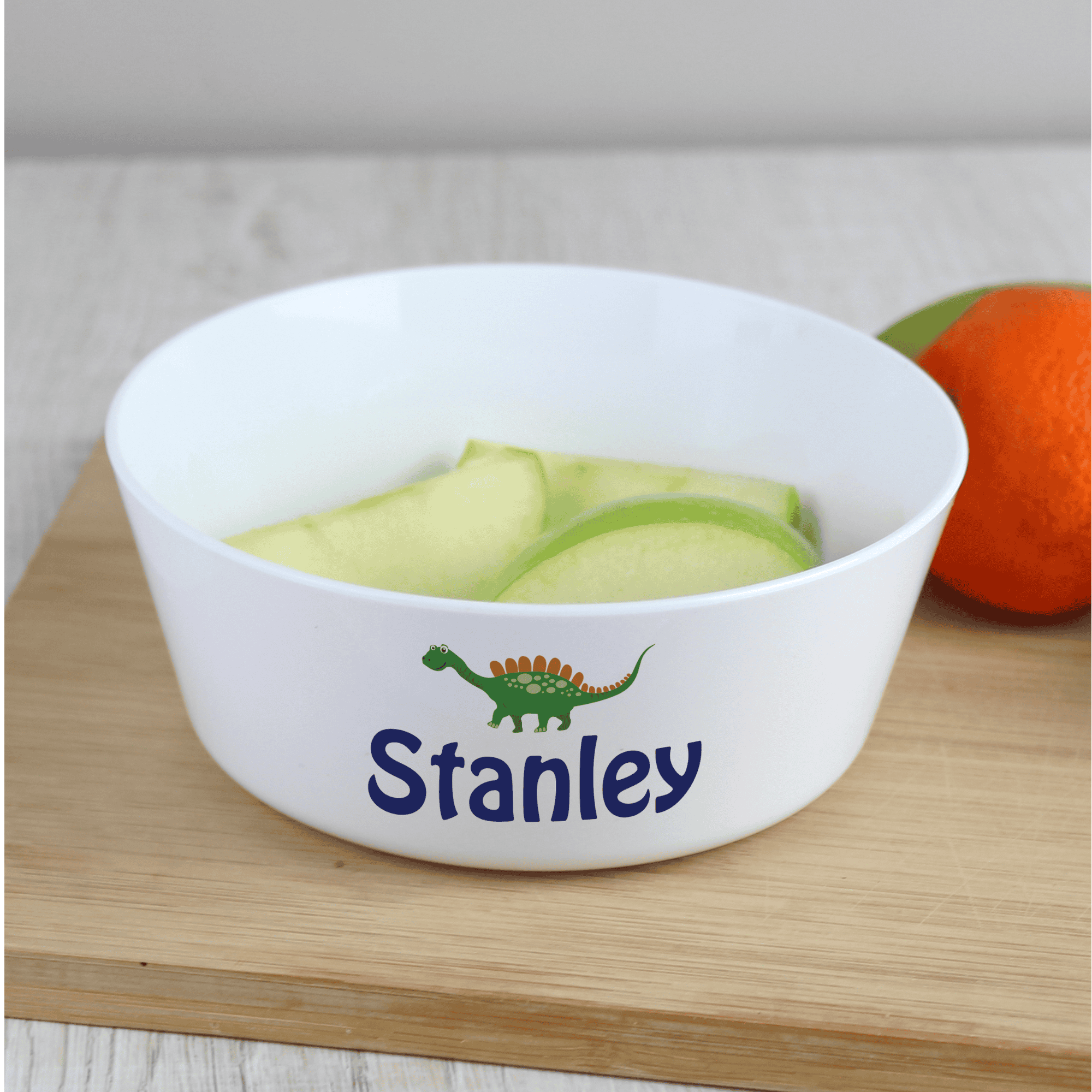 personalised dinosaur plastic bowl with any name personalised on the side of the bowl below a dinosaur image