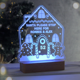 personalised gingerbread LED house showing it lit up in blue