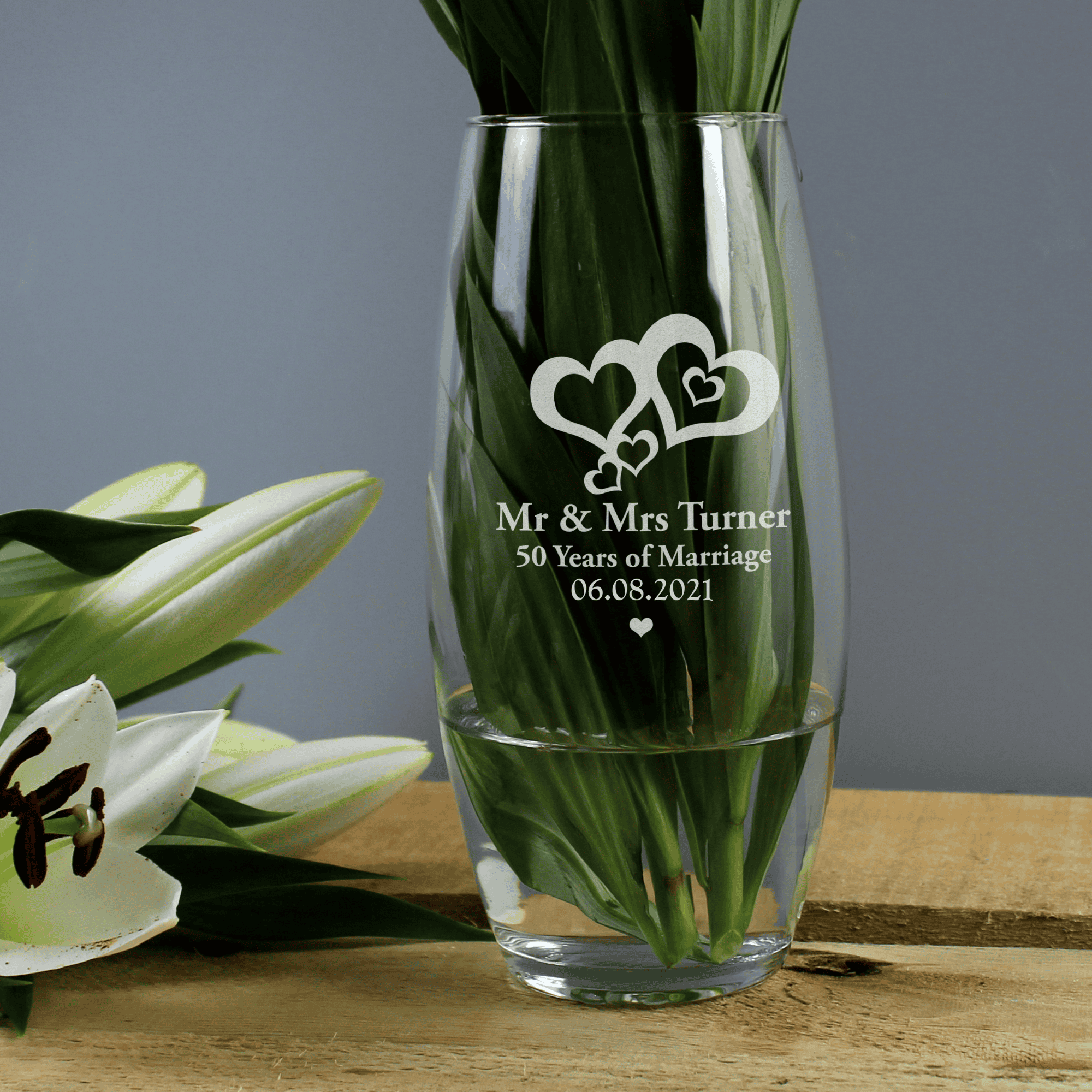 personalised love hearts bullet vase engraved with a message over 3 lines underneath the 2 engraved hearts design