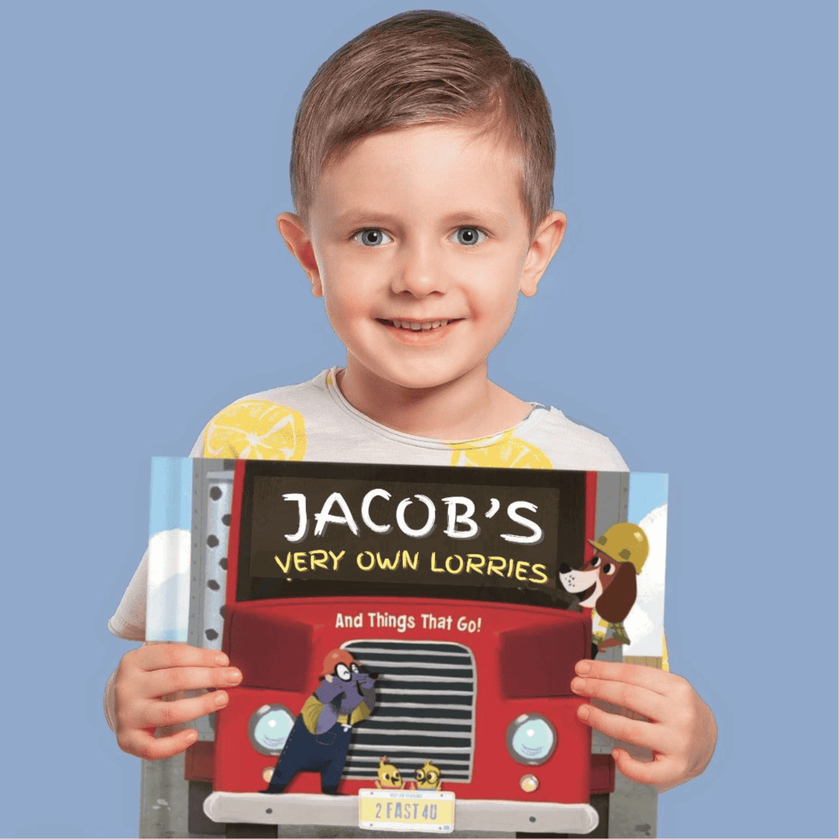 A little boy holding his very own personalised transport book