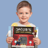 A little boy holding his very own personalised transport book