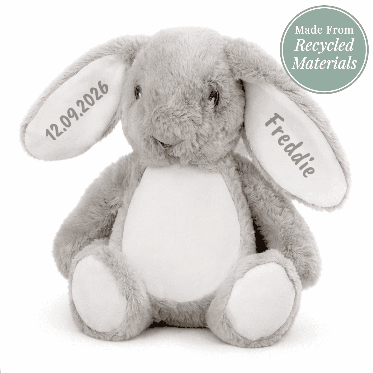 personalised soft toy bunny showing it sitting with a sign saying that it is made from recycled material