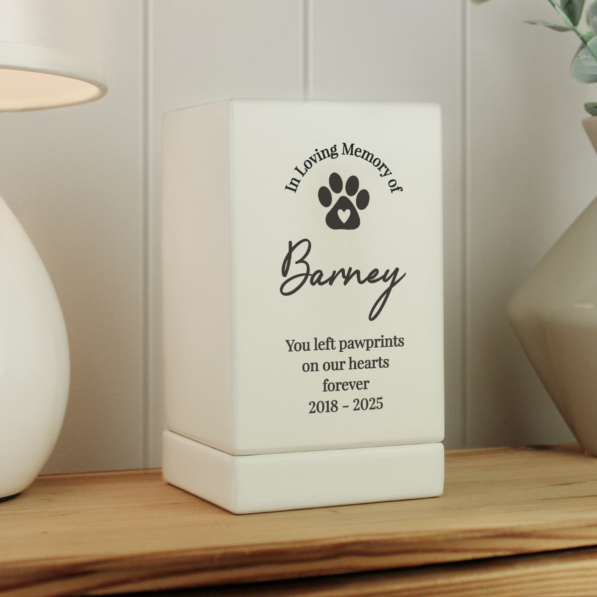 personalised wooden white pet urn showing a black paw print on the front and the personalisation over 5 lines
