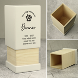 showing a black paw print on the front and the personalisation over 5 lines