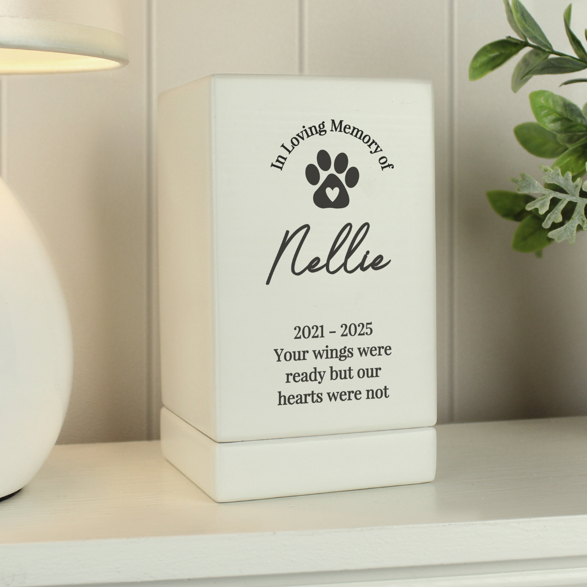 showing a black paw print on the front and the personalisation over 5 lines