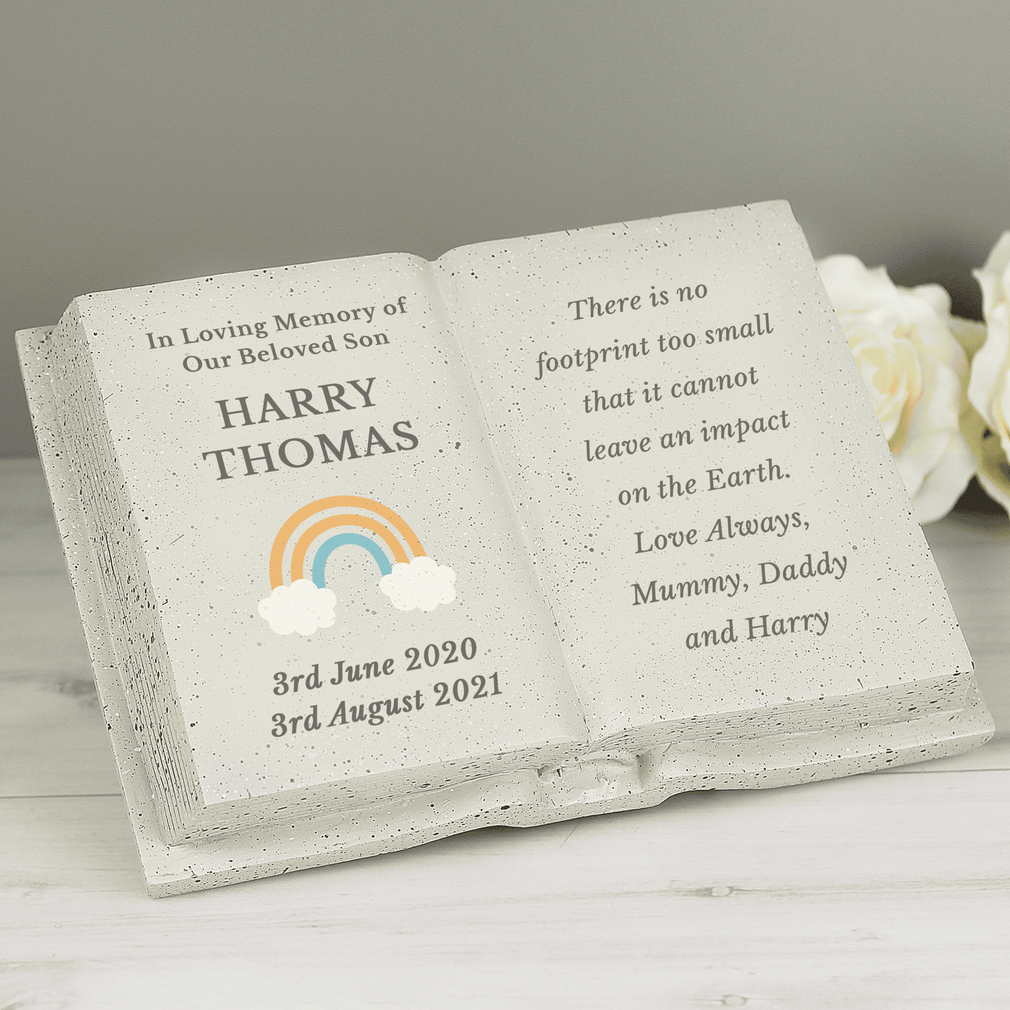 personalised rainbow memorial stone with the persons names and date on the left beside a rainbow image and any message engraved over 8 lines on the right hand side