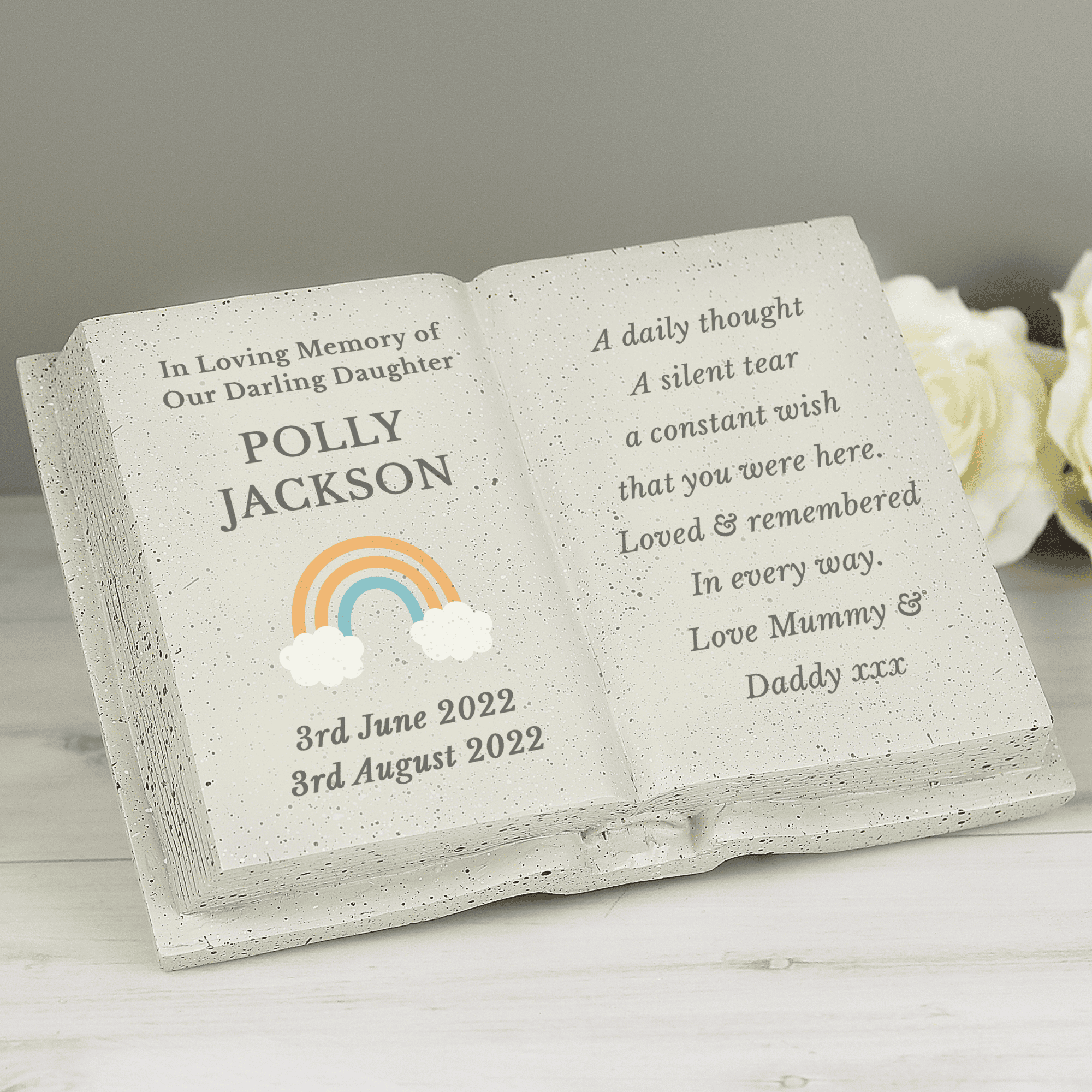 personalised rainbow memorial stone with the persons names and date on the left beside a rainbow image and any message engraved over 8 lines on the right hand side