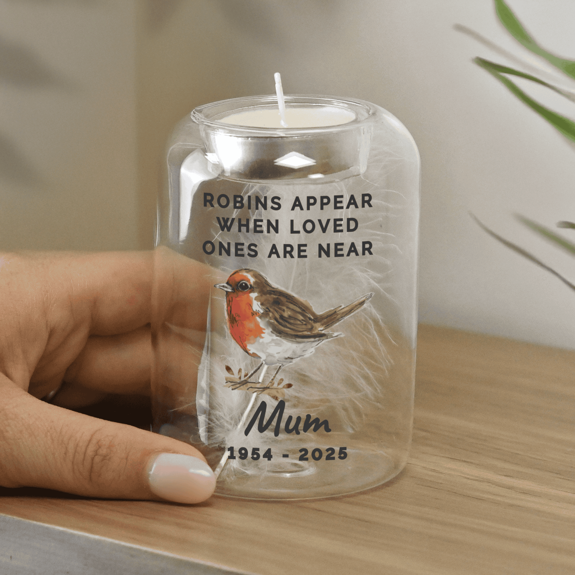 personalised robins appear memorial glass tealight holder with a feather in the centre