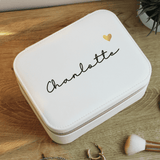 personalised white travel jewellery box with a name on the top in black writing and gold heart beside it