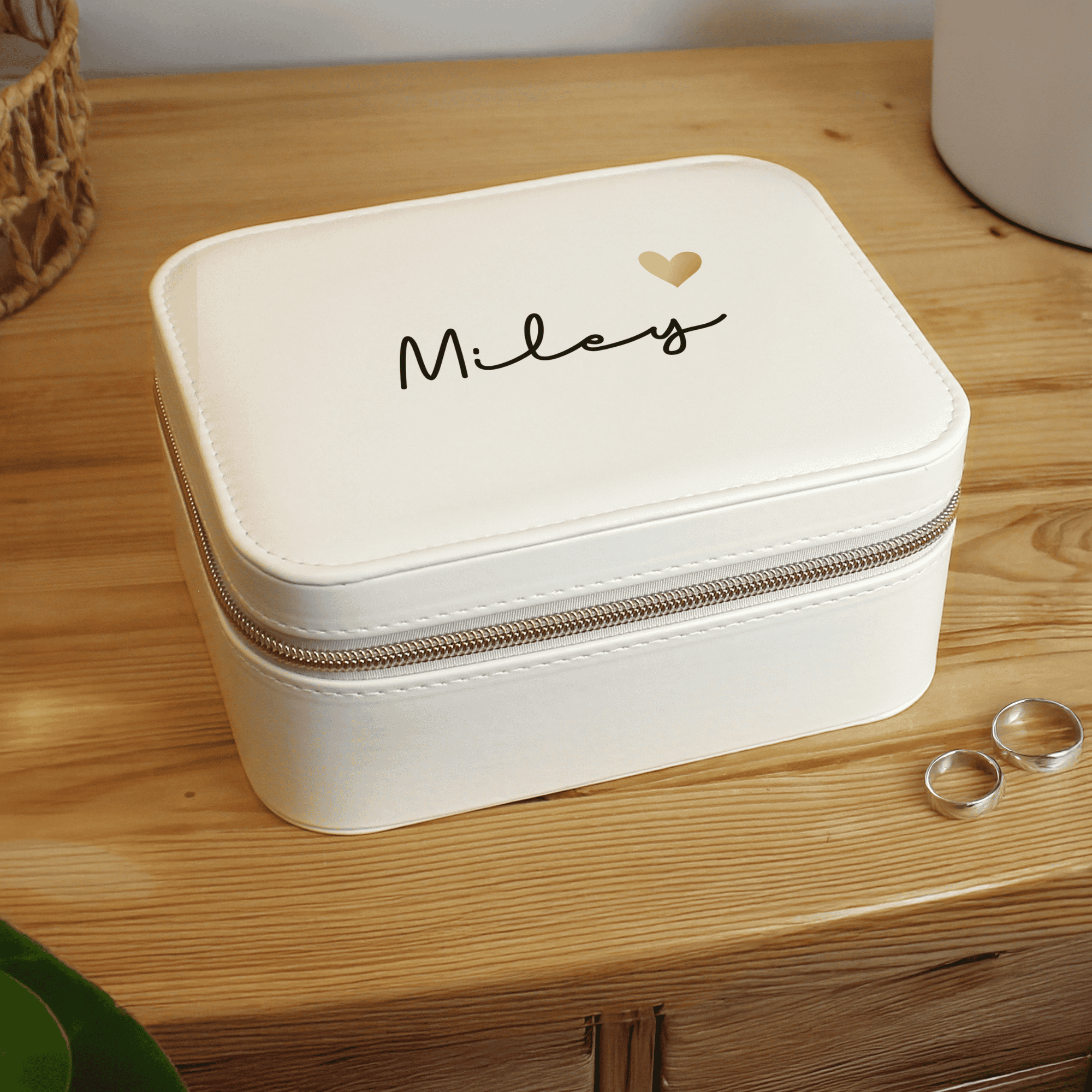personalised white travel jewellery box with a name on the top in black writing and gold heart beside it