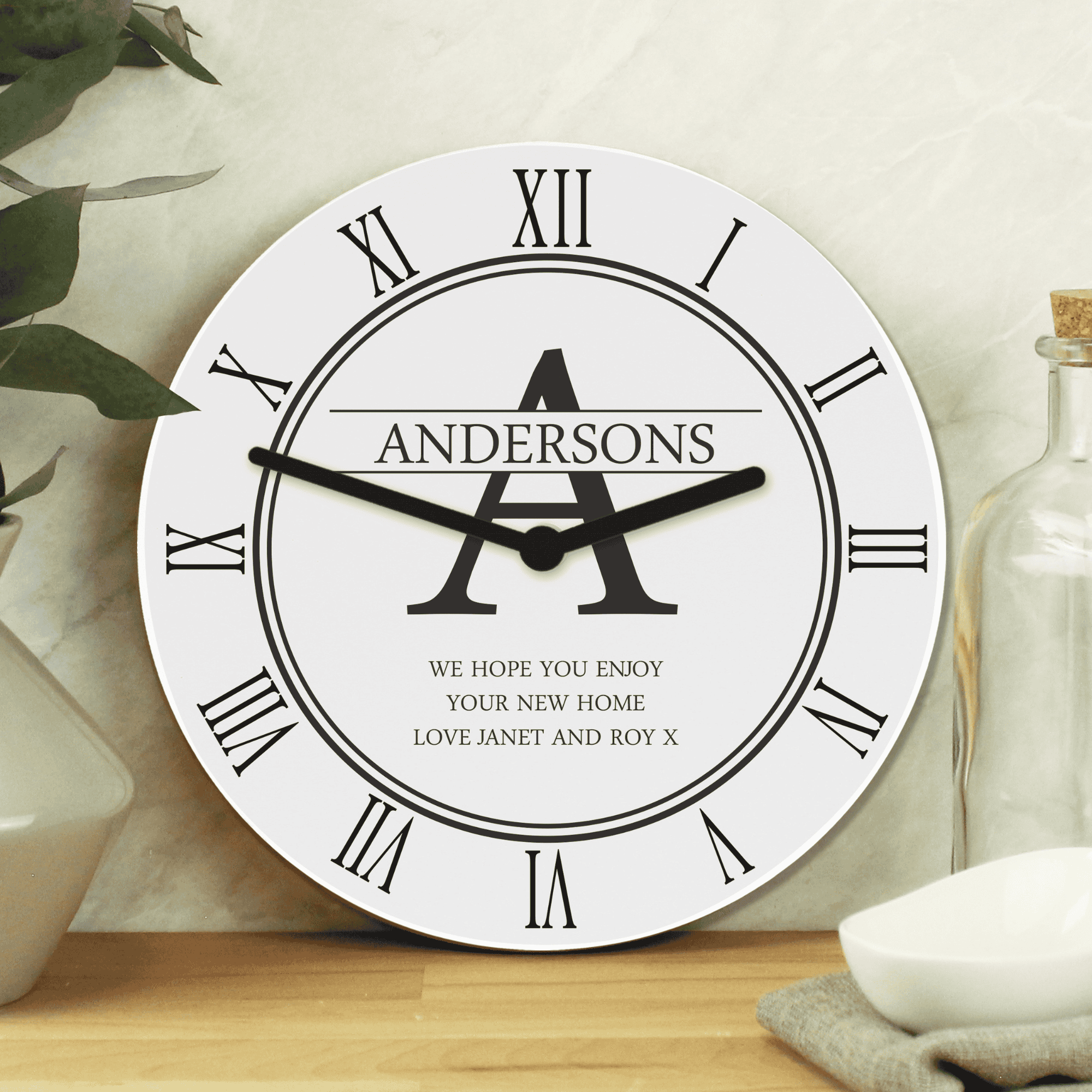 personalised white family clock with initial, surname and message.