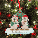 Two penguin ornaments with a Christmas tree in the background