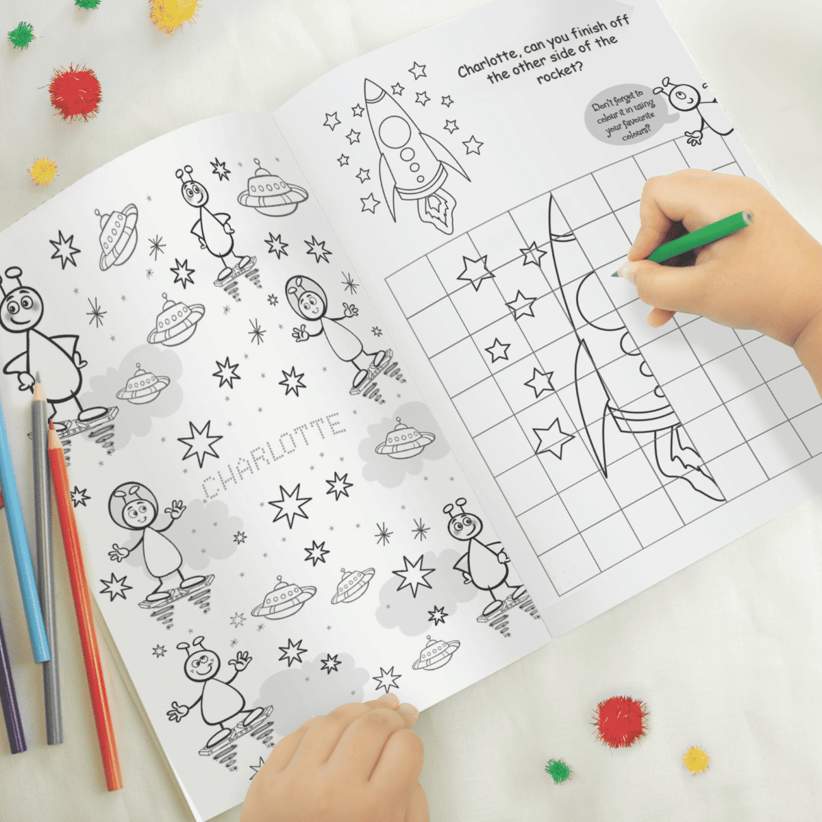 personalised space colouring book showing the inside of the book with the child's name personalised on the pages