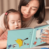 Lady and child reading the personalised alphabet book. M is for Me