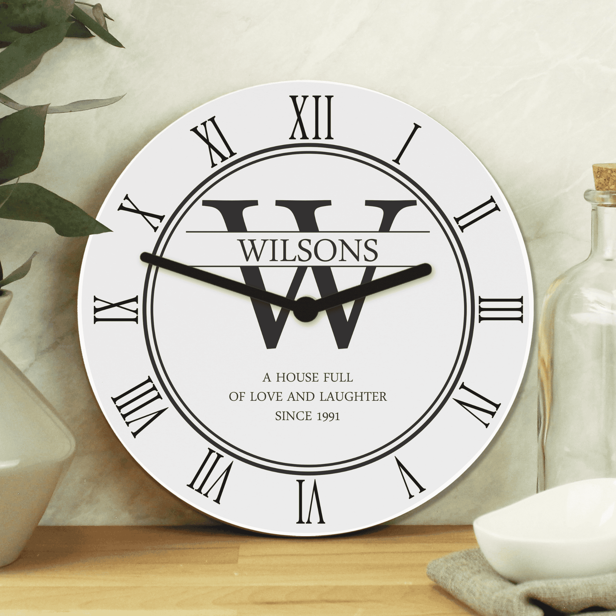 personalised white family clock with initial, surname and message.